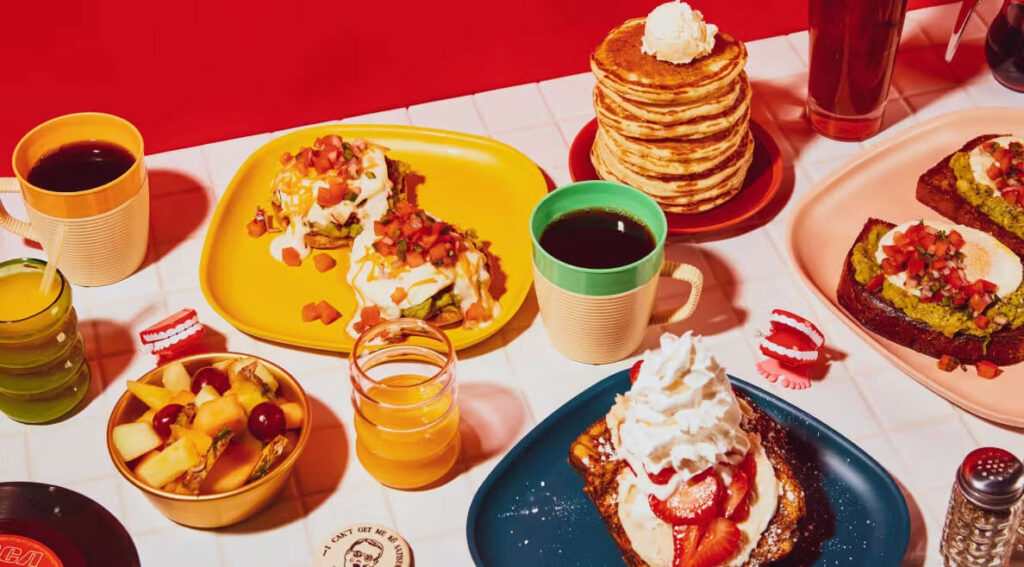 HangOverEasy Breakfast, overhead shot of pancakes, waffles, coffee and more with orange juice